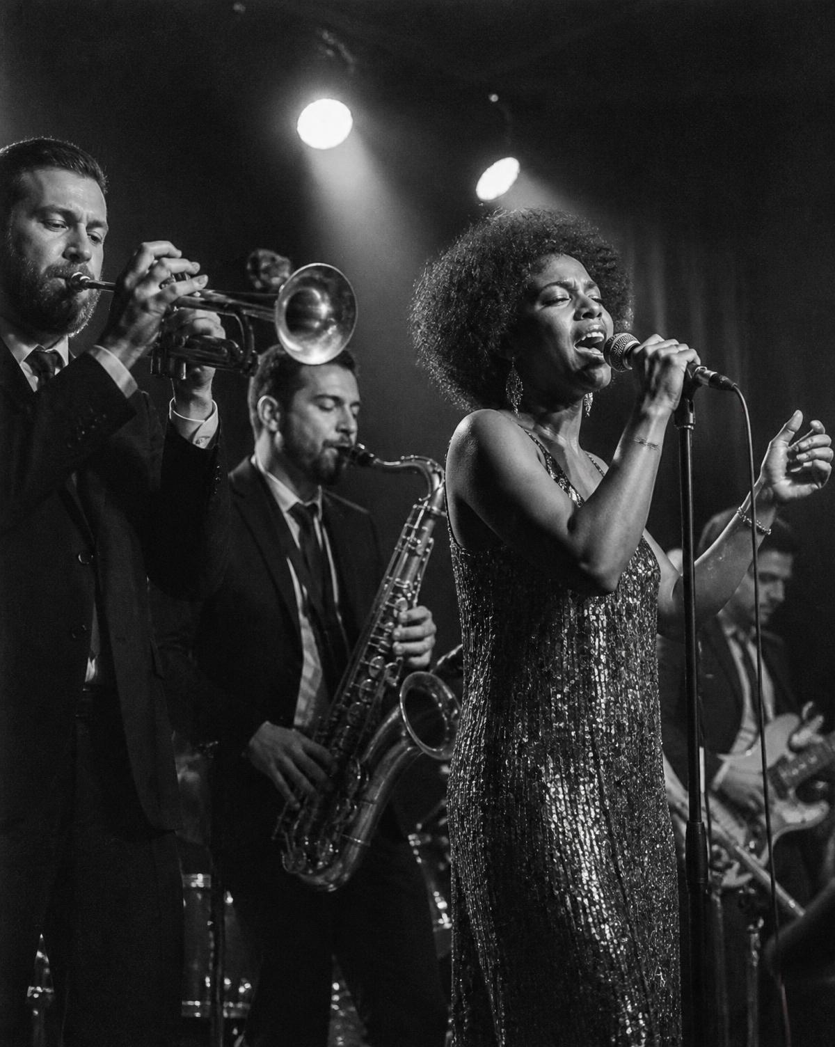 Horn section and lead vocalist on stage